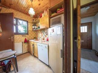 Cozy kitchen with wooden cabinets and a microwave.