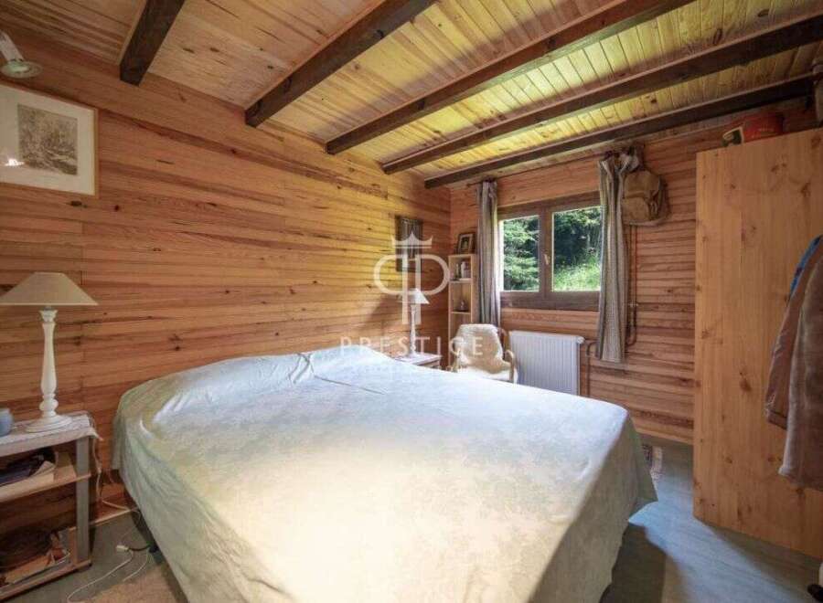 Discover the charm of this cozy bedroom, featuring beautiful wooden walls and ceiling.