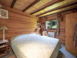 Discover the charm of this cozy bedroom, featuring beautiful wooden walls and ceiling.