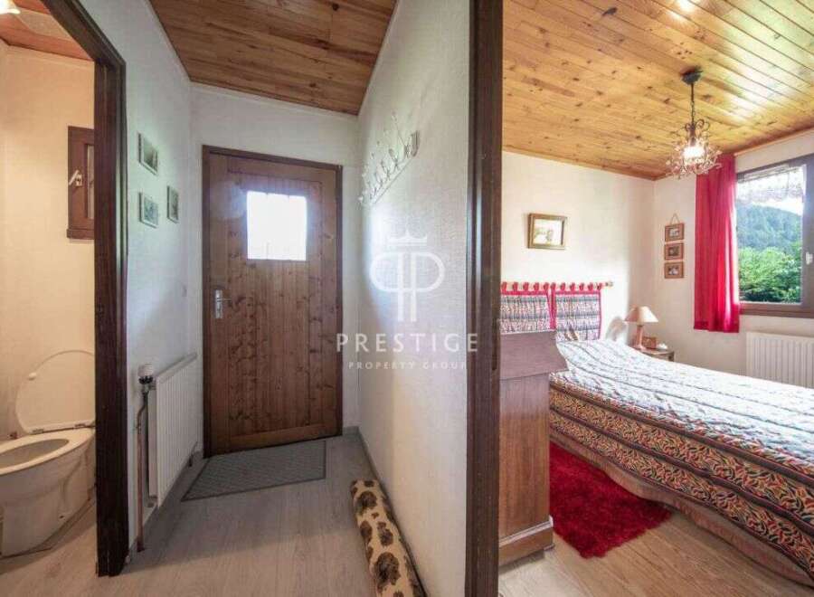 Discover the charm of this cozy property, featuring a warm wooden ceiling and inviting bedroom.