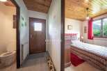 Discover the charm of this cozy property, featuring a warm wooden ceiling and inviting bedroom.