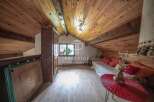 Discover the charm of this cozy attic space, featuring a warm wooden ceiling and flooring.