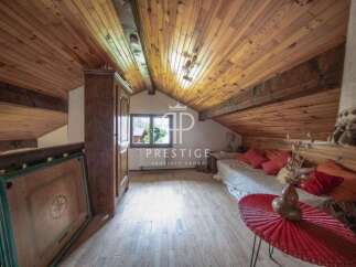Discover the charm of this cozy attic space, featuring a warm wooden ceiling and flooring.