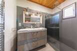 Discover a modern bathroom design with a sleek vanity and ample storage.