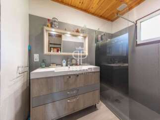 Discover a modern bathroom design with a sleek vanity and ample storage.