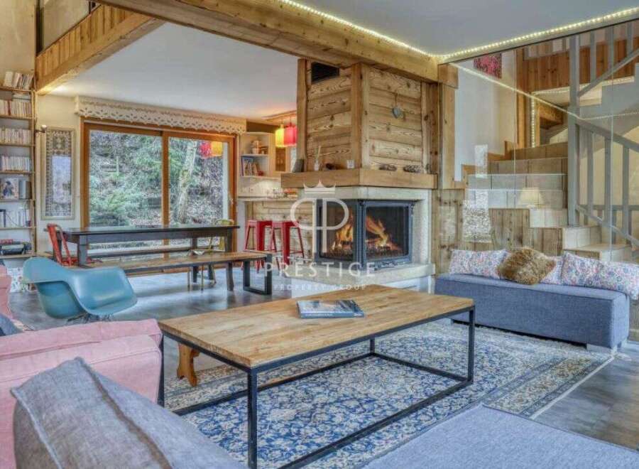 Experience the warmth of this stunning chalet, featuring a cozy fireplace and inviting living spaces.