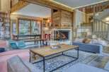 Experience the warmth of this stunning chalet, featuring a cozy fireplace and inviting living spaces.