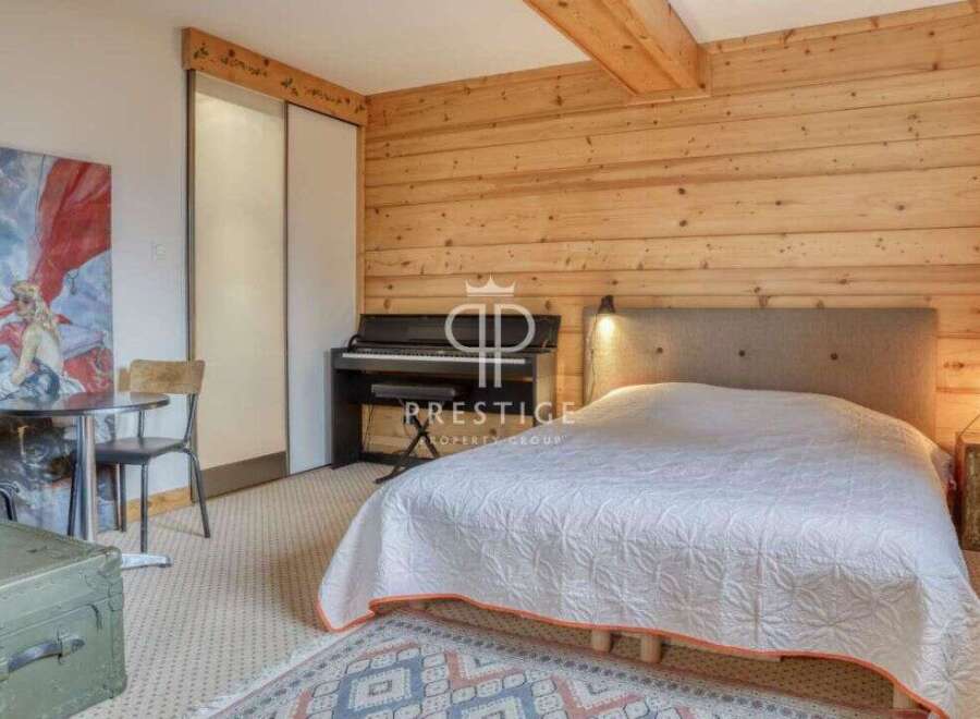 Discover the charm of this cozy bedroom featuring a grand piano and a comfortable bed.