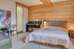 Discover the charm of this cozy bedroom featuring a grand piano and a comfortable bed.