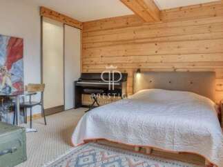 Discover the charm of this cozy bedroom featuring a grand piano and a comfortable bed.