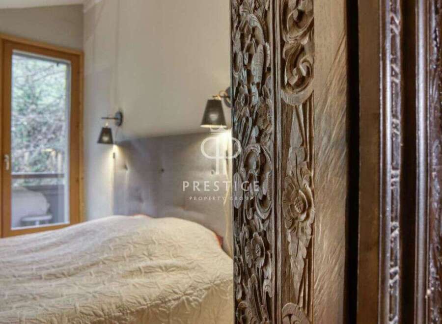 Discover the elegance of this property, featuring a beautifully carved wooden pillar that adds a touch of artistry to the space.