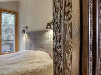 Discover the elegance of this property, featuring a beautifully carved wooden pillar that adds a touch of artistry to the space.