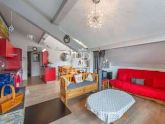 Discover this charming property featuring a cozy living space with a vibrant red sofa and a unique wooden bench.
