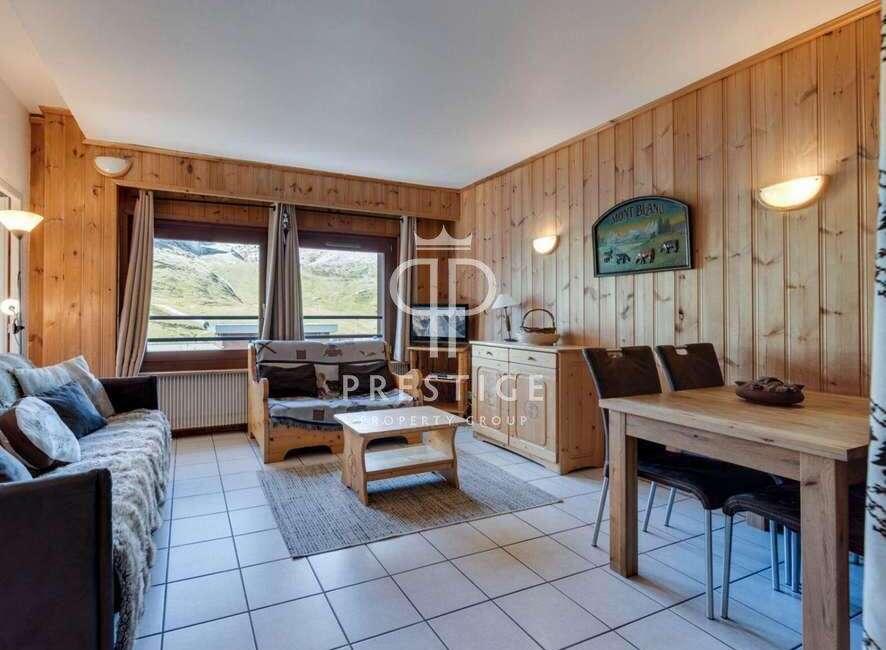 Cozy living space with wooden paneling and a charming mountain view.