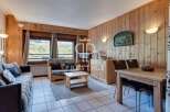 Cozy living space with wooden paneling and a charming mountain view.