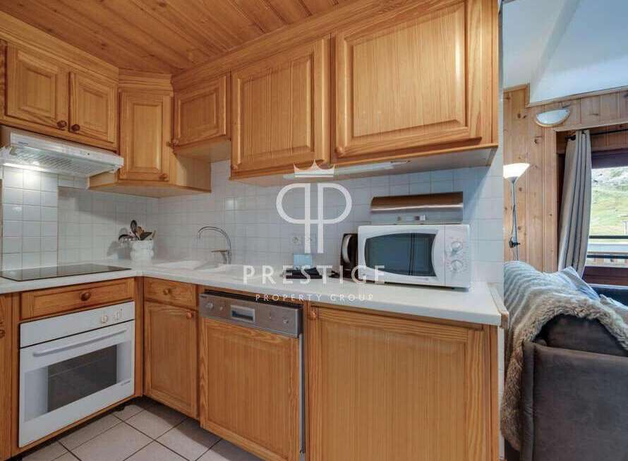 Discover a charming kitchen with wooden cabinets and a cozy ambiance.
