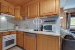 Discover a charming kitchen with wooden cabinets and a cozy ambiance.