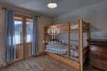 Cozy bedroom featuring a wooden bunk bed, perfect for accommodating guests.