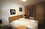 Cozy bedroom featuring a comfortable bed, perfect for a relaxing stay.