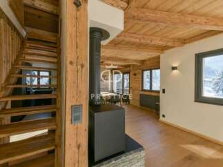 Discover the charm of this stunning property, featuring a beautifully crafted wooden staircase and a cozy fireplace.