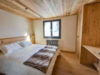 Discover the charm of this cozy bedroom, featuring a warm wooden ceiling and flooring.