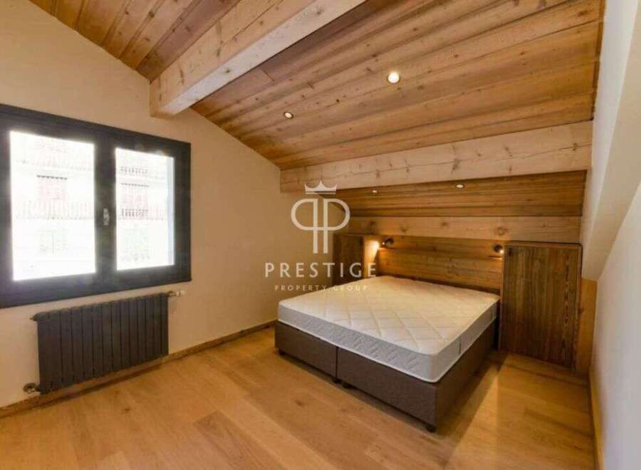 Discover the charm of this stunning property, featuring a beautifully designed bedroom with wooden accents.