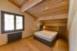 Discover the charm of this stunning property, featuring a beautifully designed bedroom with wooden accents.