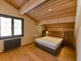 Discover the charm of this stunning property, featuring a beautifully designed bedroom with wooden accents.