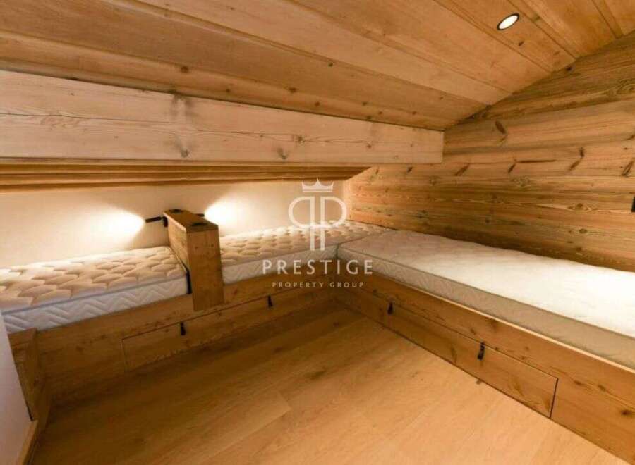 Discover the charm of this cozy bedroom featuring custom-built wooden beds.