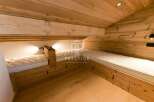 Discover the charm of this cozy bedroom featuring custom-built wooden beds.
