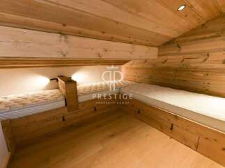 Discover the charm of this cozy bedroom featuring custom-built wooden beds.