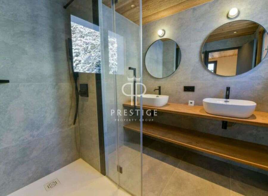Discover luxury living in this stunning property! Featuring a modern bathroom design with sleek fixtures and a spacious shower.