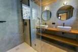 Discover luxury living in this stunning property! Featuring a modern bathroom design with sleek fixtures and a spacious shower.