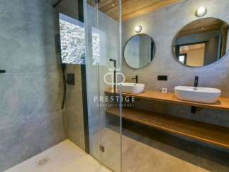Discover luxury living in this stunning property! Featuring a modern bathroom design with sleek fixtures and a spacious shower.