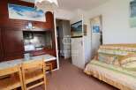 Cozy apartment with a well-equipped kitchenette, perfect for preparing meals.