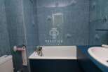 Discover this charming bathroom featuring a classic design with blue tiles.