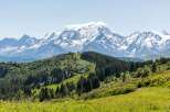 Experience the breathtaking beauty of the mountains, with lush green hills and majestic snow-capped peaks.