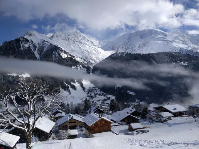 Village covered with snow near mountain