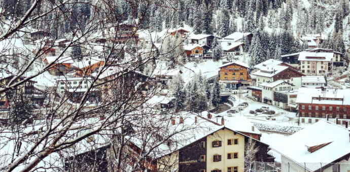 Houses near snow covered Austrian mountain