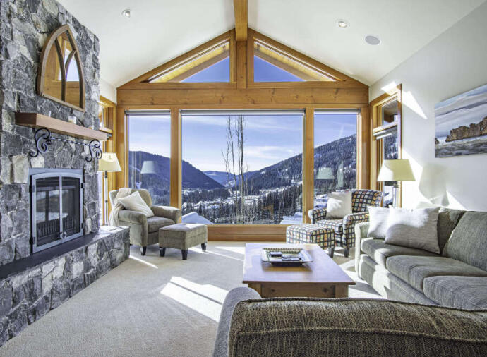 Interior of a living room looking out to the mountains in  Sun Peaks, British Columbia, Canada.
