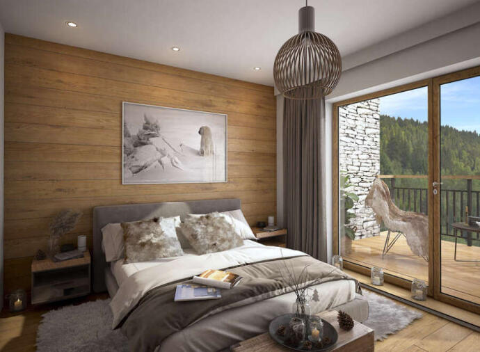 Bedroom with a view of the mountains in a ski chalet in Les Gets, France. 