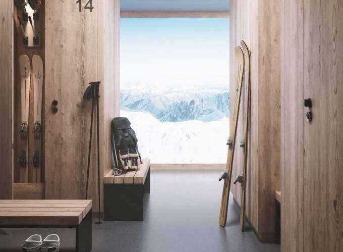 View of mountains from an open door in a ski home in La Plagne, France.  