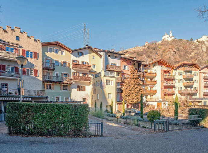 Colorful apartment buildings near a hillside.