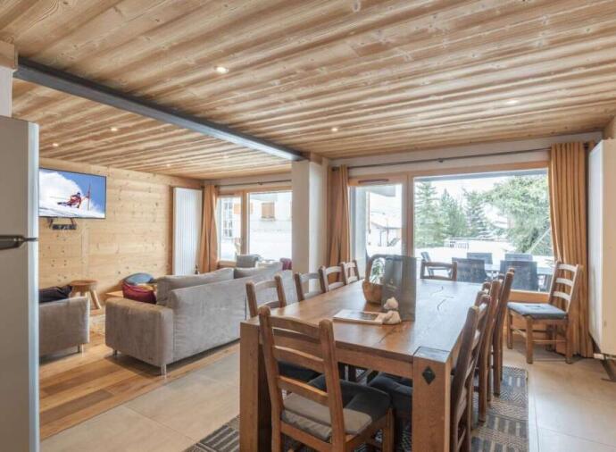 Cozy dining and living area with wooden interiors.