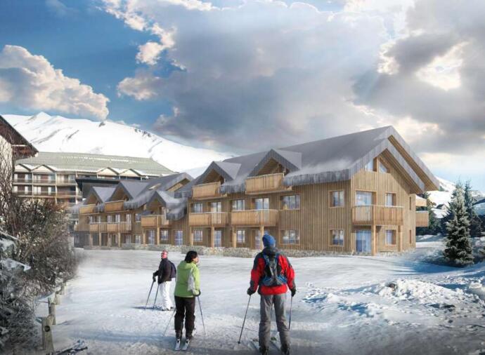 Skiers near wooden lodges in a snowy mountain resort.