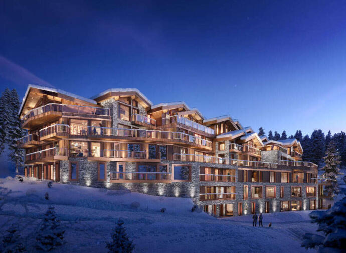 A large chalet-style building with balconies and warm lights, set in a snowy landscape at twilight.
