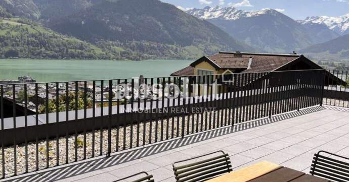 Terrace view of the mountains and other properties from a ski chalet in Zell Am See, Austria.