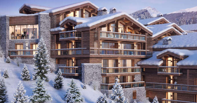 Snow-covered alpine lodge with wooden balconies and pine trees on a snowy hillside.